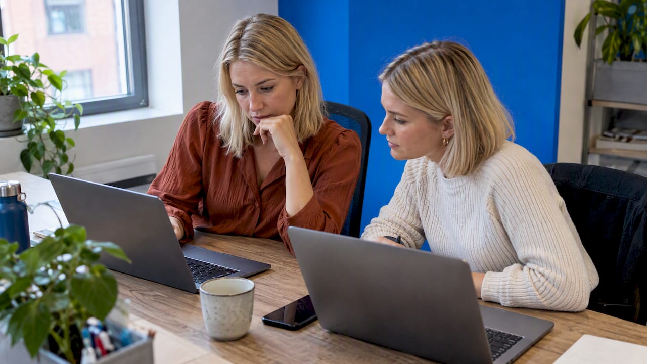 Blond business women comparing automation tools