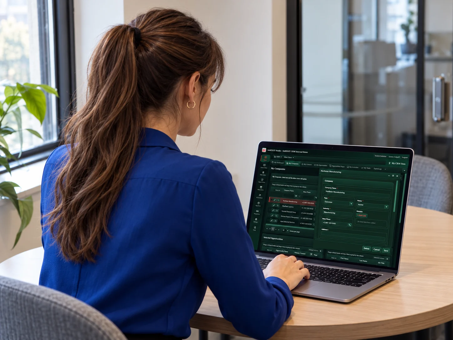 Woman using SoftEXIT Studio on a laptop